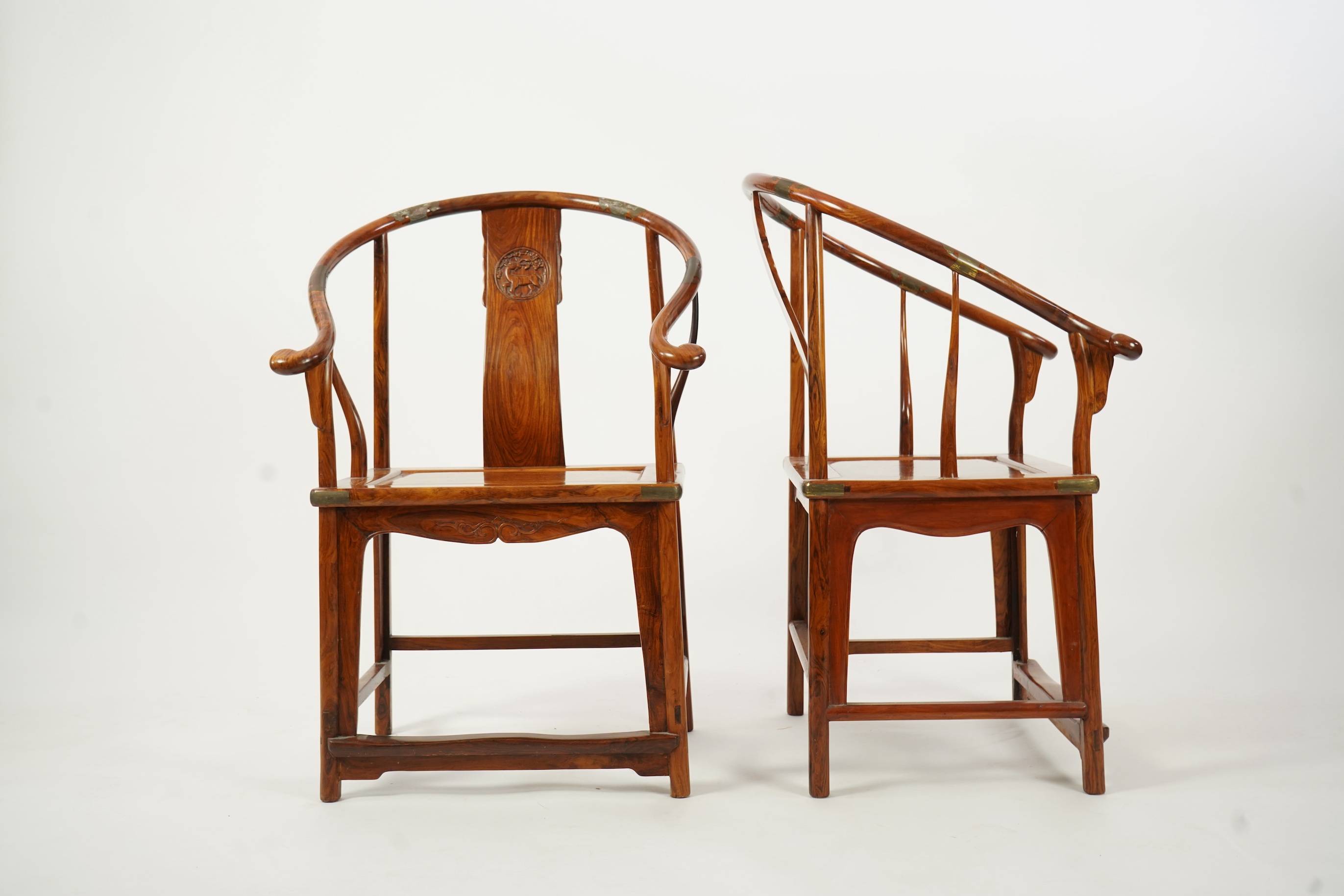 A pair of Chinese huanghuali and brass mounted horseshoe-back armchairs, quanyi, 19th century